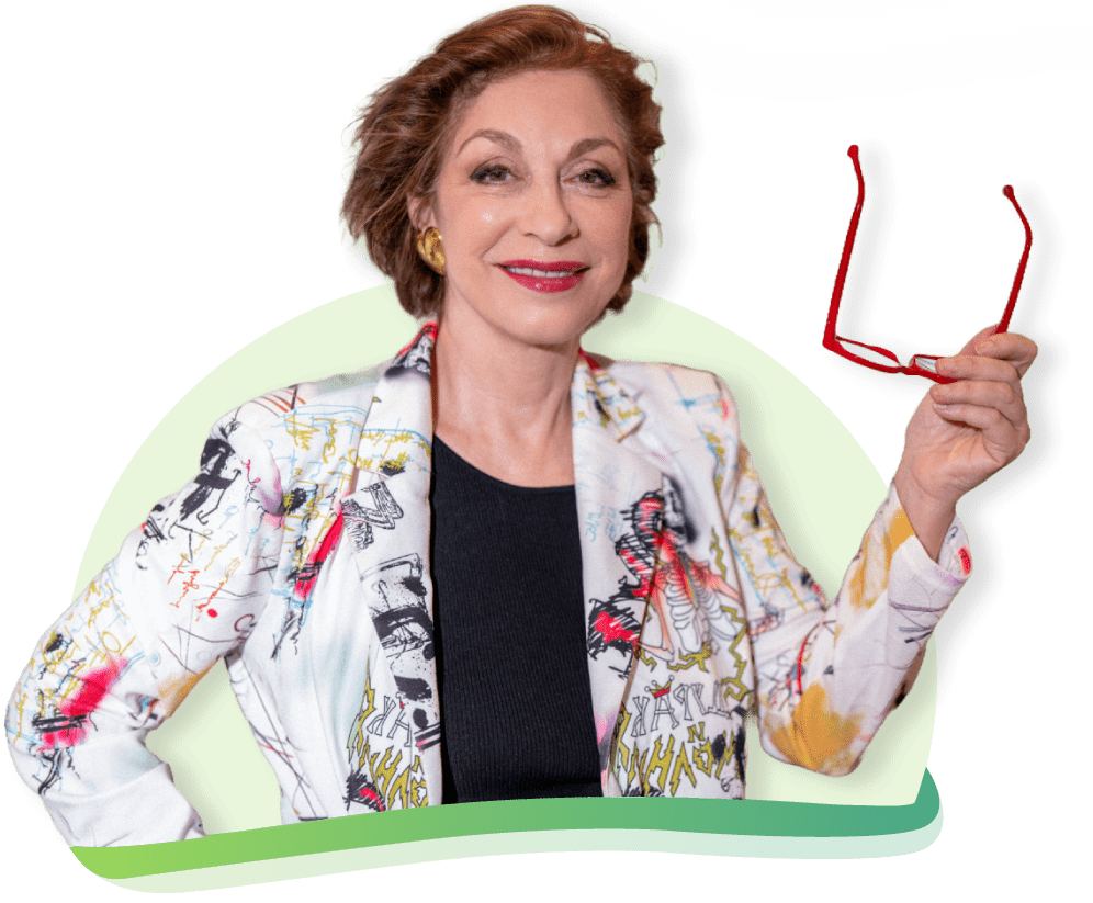 Sylvie Beljanski, CEO of Maison Beljanski, smiling and holding her red glasses