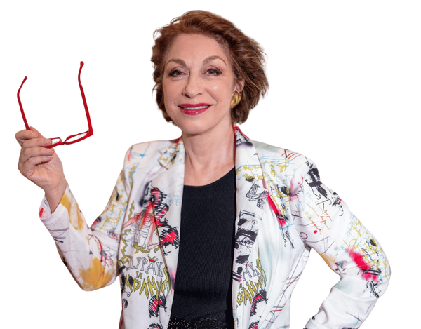 Sylvie Beljanski, CEO of Maison Beljanski, smiling and holding her red glasses